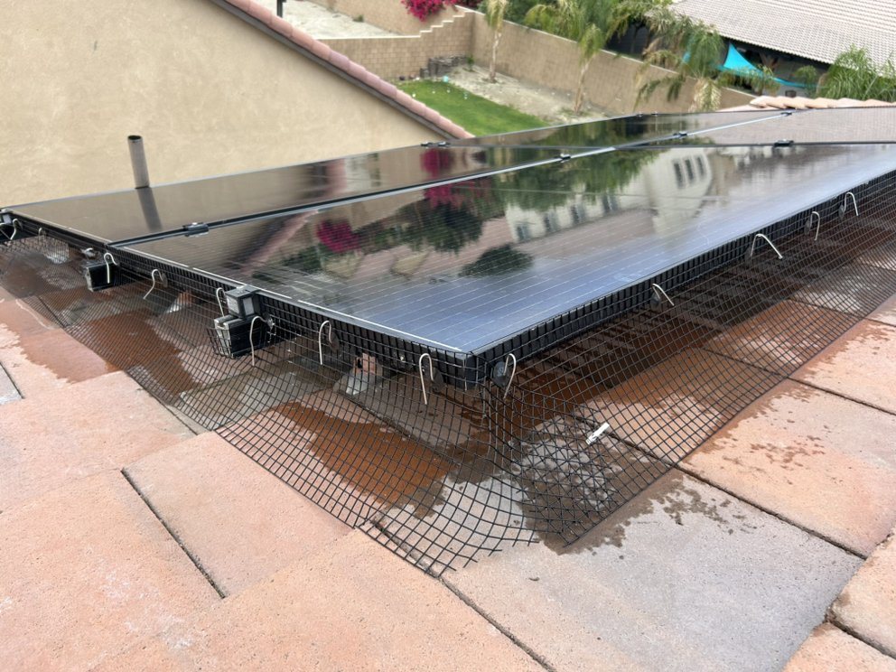 Bird proofing mesh installed around solar panels by Glossy